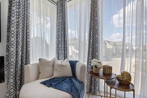 a white chair in a room with a large window at Festive Villa 1 Heart of Richardson TX 6BR 5BA in Richardson