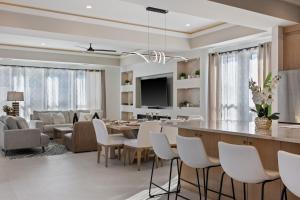 a living room and dining room with a dining table at Festive Villa 1 Heart of Richardson TX 6BR 5BA in Richardson