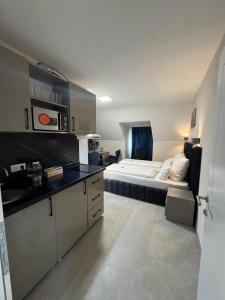 a kitchen with a bed in the middle of a room at Deluxe Apartment am Rhein in Bonn