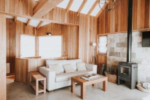 a living room with a white couch and a fireplace at Bosque Nevado in San Martín de los Andes