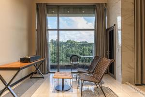a room with a desk and chairs and a large window at Allee Hotel in Yongin