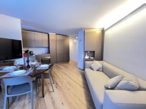 a living room with a couch and a dining room at Alpine glow - sophisticated ski in - ski out in Breuil-Cervinia +13 photos