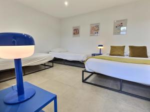 a room with two beds and a lamp on a table at Pop Centre in Valence +7 photos