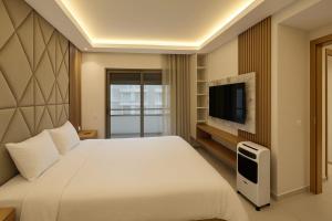 a hotel room with a bed and a television at Margueri House in Mohammedia