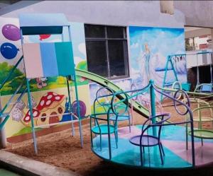 a playground with a slide in front of a mural at Havena Homes-3 Bedroom Apartment at Kilimani in Nairobi