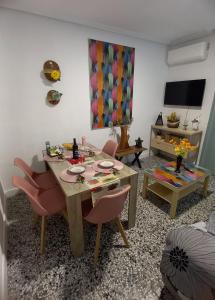 a living room with a table and chairs and a television at Casa Paraíso Interior Catedral Jaén in Jaén +35 photos