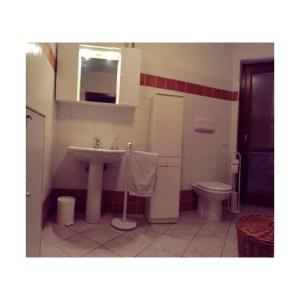 a bathroom with a sink and a toilet at La Terrazza sul Golfo in Golfo Aranci