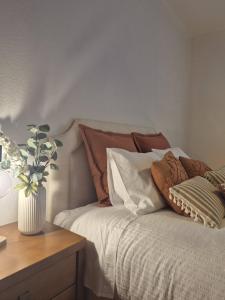 a bedroom with a bed with pillows and a table at Luar de Prata by Portus Alacer in Crato
