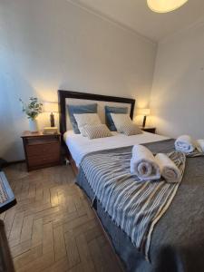 a bedroom with a large bed with towels on it at Luar de Prata by Portus Alacer in Crato