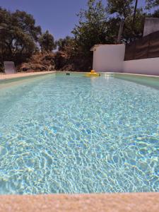 a swimming pool with a yellow object in the water at Luar de Prata by Portus Alacer in Crato