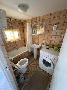 a bathroom with a toilet and a sink and a tub at Nobleza Nava del Rey in Nava del Rey