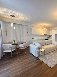 a living room with a couch and a table at PURE Apartman -free private garage in Nyíregyháza +15 photos