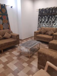a living room with couches and a coffee table at Guest House Furnished Villa Bahria Town Karachi in Karachi