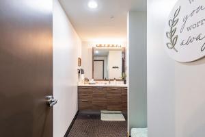 a bathroom with a sink and a mirror at Modern-Chic Loft in Heart of Dallas in Dallas