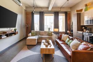 a living room with a couch and a table at Modern-Chic Loft in Heart of Dallas in Dallas