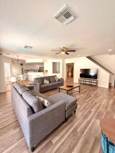 a living room with a couch and a tv at Minutes from Sea World and Fiesta Texas in San Antonio