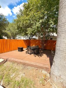 a patio with a table and a bench next to a fence at Minutes from Sea World and Fiesta Texas in San Antonio