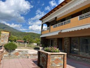 a building with a flower pot on the front of it at Dimitra's house in Aridaia