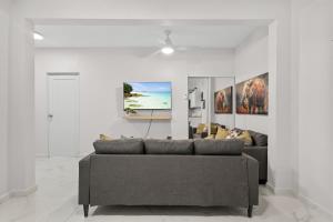 a living room with a couch and a table at Modern 3 Bedroom Apartment Full Kitchen Ac in Manati