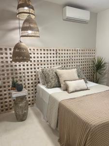 a bedroom with a bed with pillows on it at Pousada Estrela do Norte in Pipa