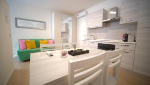 a kitchen with a table and a couch in a room at Sky House Sant'Orsola in Bergamo