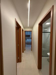 a hallway of a bathroom with a walk in shower at High standard apartment, well located in Anápolis