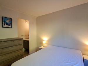 a bedroom with a white bed and a dresser with a lamp at Appartement spacieux et moderne, 3 pièces, 6 pers, proche pistes et commerces - Flaine Forêt - FR-1-425-28 in Flaine