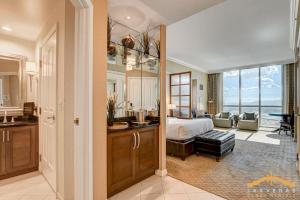 a bedroom with a bed and a bathroom with a sink at MGM Signature-31-816 Jacuzzi Studio in Las Vegas