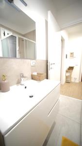 a bathroom with a white sink and a mirror at Sky House Sant'Orsola in Bergamo +14 photos