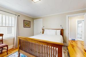 a bedroom with a large bed and a wooden rail at Our Home on a Hill in Bethel