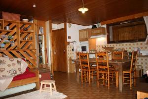 a kitchen and dining room with a table and chairs at Les Myosotis in Arêches