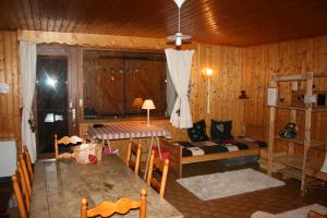 a living room with a table and a couch at Les Myosotis in Arêches