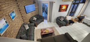 an overhead view of a living room with couches at 11 Seesonnet beach flat in Scottburgh