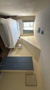 a small room with a bed and a window at StayWise3 in Middlesbrough