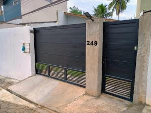 a black garage door with the number on it at Quarto vista mar São Sebastião in São Sebastião
