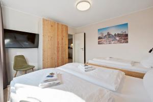 Postel nebo postele na pokoji v ubytování SNOWFLAKE Zentrale Lage Bikepark & Piste