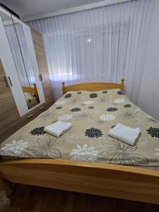a bed with two pillows on it in a bedroom at Andjelka apartman in Modriča