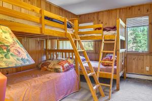 a bunk bed room with two bunk beds in a cabin at Riverfront Home with Hot Tub Near Killington Resort in West Bridgewater