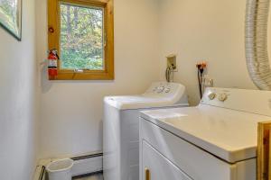 a laundry room with a washing machine and a window at Riverfront Home with Hot Tub Near Killington Resort in West Bridgewater +23 photos