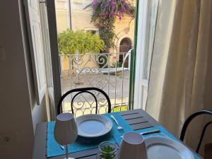 a table with plates on it with a view of a balcony at Il portale in Tropea