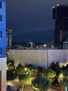 a large building with trees in front of a city at Tirana center view in Tirana