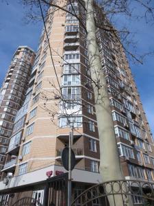 a tall building with a large tree in front of it at Just comfort in Odesa