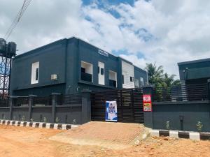 Un edificio azul con un cartel delante. en The Majj Hotel Benin City, en Benin City
