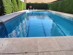 a swimming pool with blue water in a yard at AMAZING ROOFTOP, 70 M TERRACE,Pool,BEACH,PARKING in Málaga