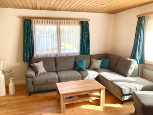 a living room with a couch and a table at Chasa ARLU in Samnaun