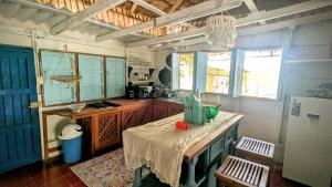 a kitchen with a table and a refrigerator at Casa Corazón in El Cuyo