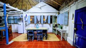 a kitchen with a table and some blue cabinets at Casa Corazón in El Cuyo