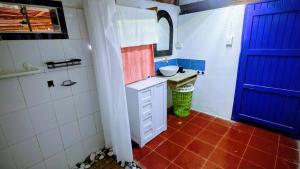 a bathroom with a sink and a blue door at Casa Corazón in El Cuyo