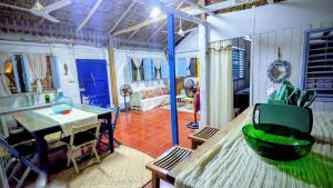 a living room with a table and a room with a table and a chair at Casa Corazón in El Cuyo +8 photos