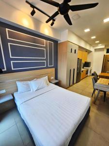 a bedroom with a large bed with a ceiling fan at The Infinitum Eternity Luxe By Crystal KLCC in Kuala Lumpur